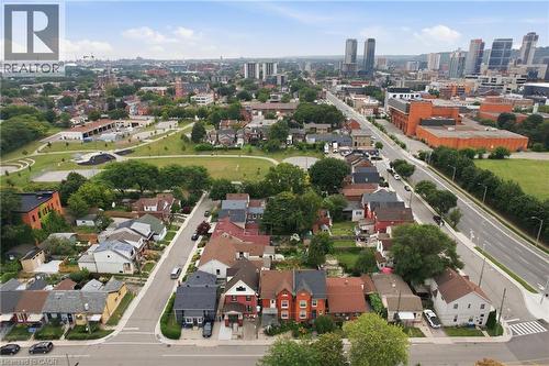 Aerial perspective highlighting residential properties, public green spaces, and urban infrastructure - 128 Hess Street N, Hamilton, ON - Outdoor With View