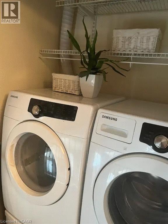 Laundry area featuring a side-by-side washer and dryer, white wire shelving, and neutral wall paint - 4000 Medland Drive, Burlington, ON - Indoor Photo Showing Laundry Room