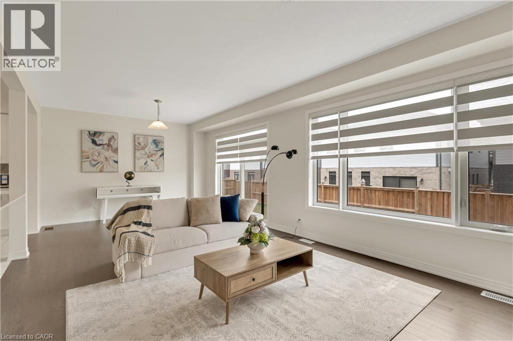 Recessed lighting, wood-finish flooring, white walls, and multiple windows with layered window treatments - 285 Broadacre Drive, Kitchener, ON - Indoor Photo Showing Living Room