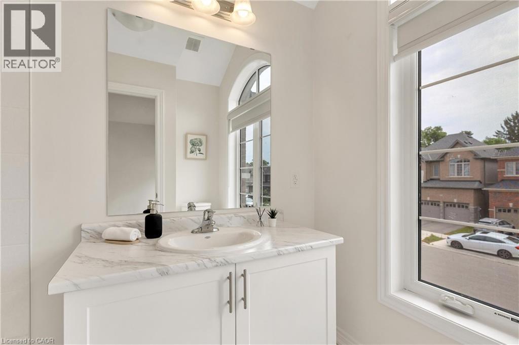 White vanity with a single basin sink, chrome faucet, and a marbled countertop - 285 Broadacre Drive, Kitchener, ON - Indoor Photo Showing Bathroom