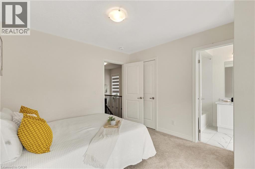 Neutral wall color, carpeted flooring, white trim, solid core doors, and a flush mount ceiling light - 285 Broadacre Drive, Kitchener, ON - Indoor Photo Showing Bedroom