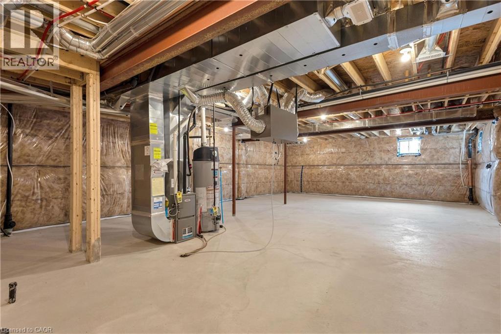 Unfinished basement with concrete flooring and exposed ceiling joists - 285 Broadacre Drive, Kitchener, ON - Indoor Photo Showing Basement