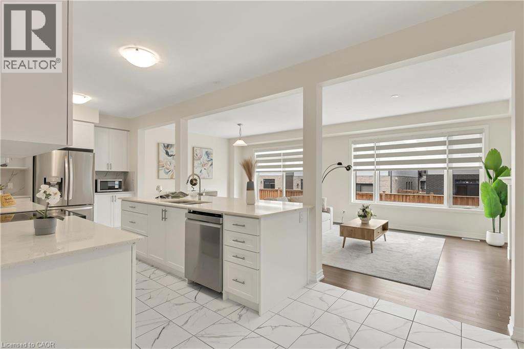 Kitchen featuring white cabinetry, light-toned countertops, stainless steel appliances, and tile flooring - 285 Broadacre Drive, Kitchener, ON - Indoor Photo Showing Kitchen With Stainless Steel Kitchen With Upgraded Kitchen