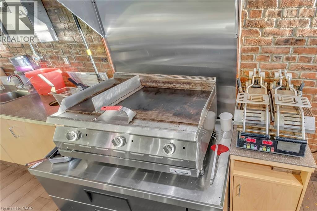 Stainless steel commercial griddle with an integrated range hood - 589 Fairway Road S, Kitchener, ON