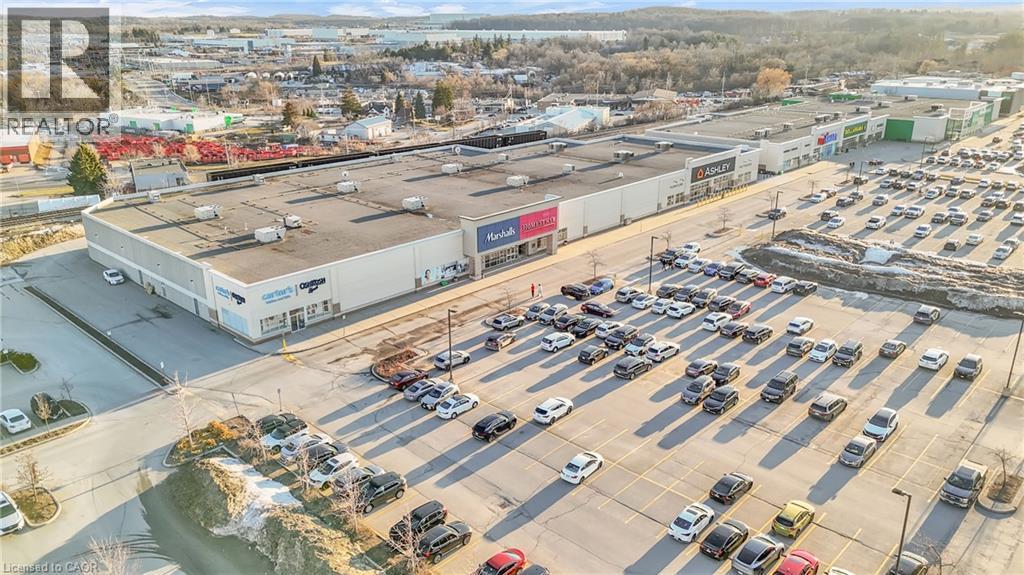 Expansive commercial property with a large, paved parking area - 589 Fairway Road S, Kitchener, ON