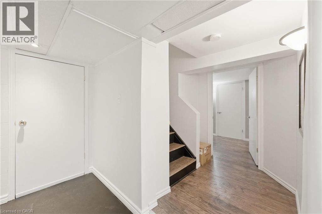 Basement landing opening to kitchen on one side and living room on the other - 481 Upper Gage Avenue, Hamilton, ON - Indoor Photo Showing Other Room