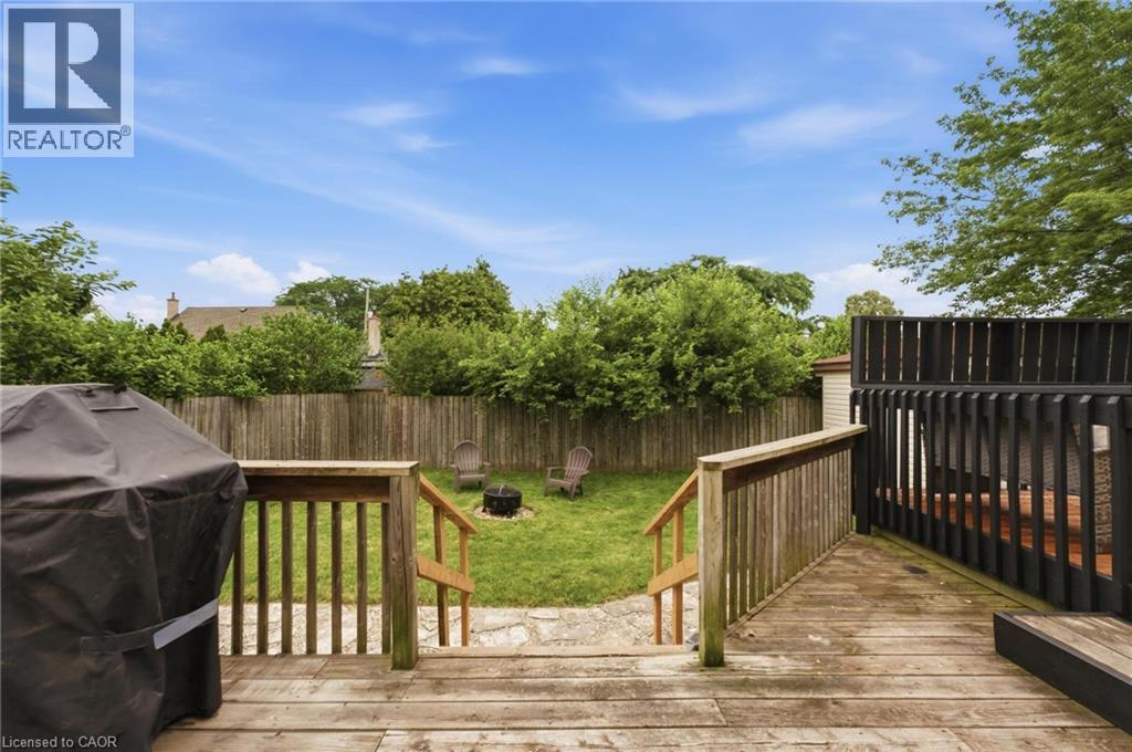 Multi-level wood deck with steps leading to a manicured lawn - 481 Upper Gage Avenue, Hamilton, ON - Outdoor With Deck Patio Veranda