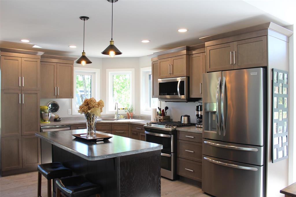The kitchen has built-in microwave with "bump out" fan. Stainless steel appliances and loads of storage space. - 7 Dalvik Road, Gimli Rm, MB - Indoor Photo Showing Kitchen With Stainless Steel Kitchen With Upgraded Kitchen
