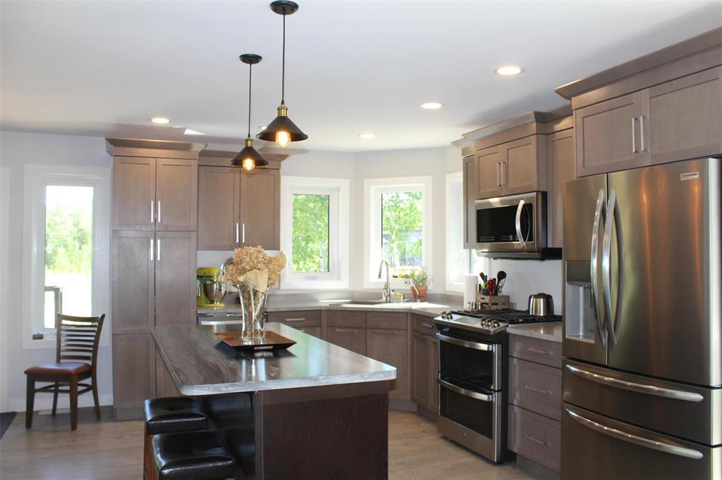 Another view of the kitchen with large island and beautiful window for lot's of natural light. - 7 Dalvik Road, Gimli Rm, MB - Indoor Photo Showing Kitchen With Stainless Steel Kitchen With Upgraded Kitchen