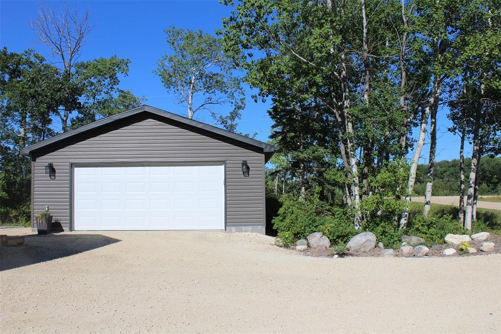 Double car garage has "smart" garage door opener. No more brushing snow off the cars! - 7 Dalvik Road, Gimli Rm, MB - Outdoor