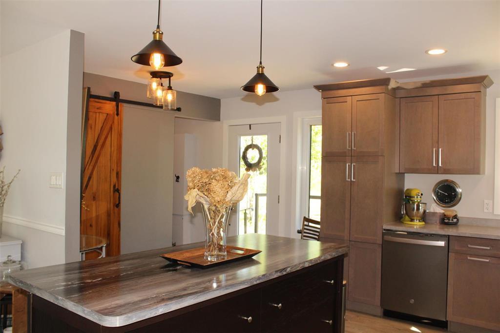 Behind the barn door is additional storage or could be used for a large pantry. Door is entry from the side of the house. - 7 Dalvik Road, Gimli Rm, MB - Indoor Photo Showing Kitchen
