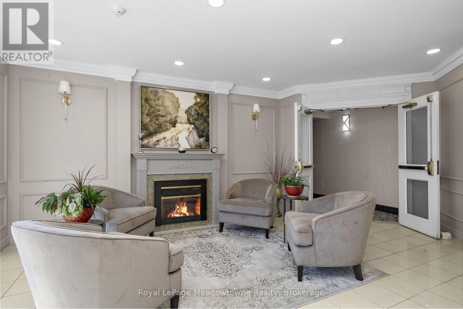 210 - 2075 Amherst Heights Drive, Burlington (Brant Hills), ON - Indoor Photo Showing Living Room With Fireplace