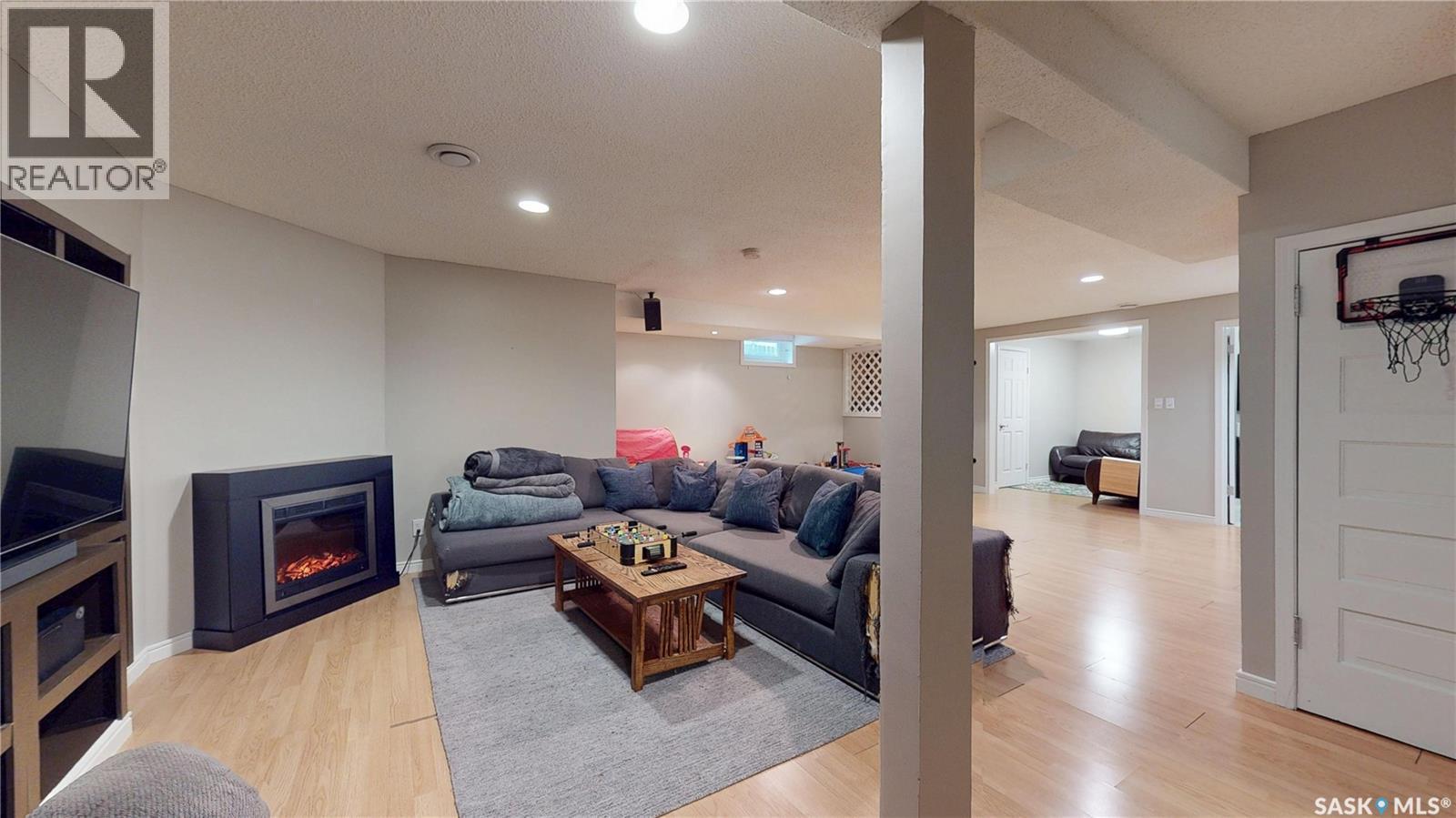 3107 Andreychuk Place E, Regina, SK - Indoor Photo Showing Other Room With Fireplace