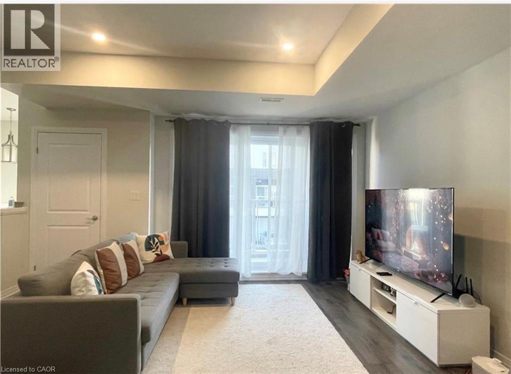 Recessed lighting, wood-finish flooring, and a white built-in media console - 17 Visionary Avenue, Kitchener, ON - Indoor
