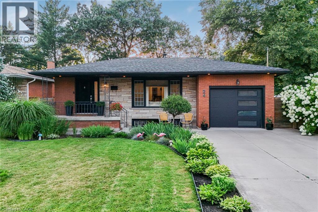 Brick and stone exterior with a dark asphalt shingle roof - 24 Garvey Crescent, Hamilton, ON - Outdoor With Deck Patio Veranda