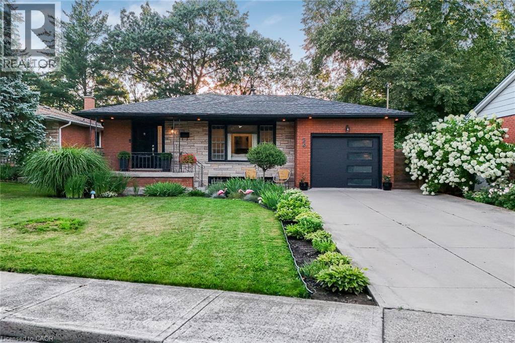 Brick and stone facade with a dark shingle roof - 24 Garvey Crescent, Hamilton, ON - Outdoor With Deck Patio Veranda With Facade