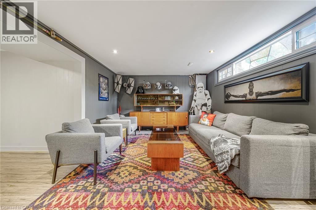 Recessed lighting, wood-finish flooring, and a built-in mid-century modern style cabinet with display shelving - 24 Garvey Crescent, Hamilton, ON - Indoor Photo Showing Living Room