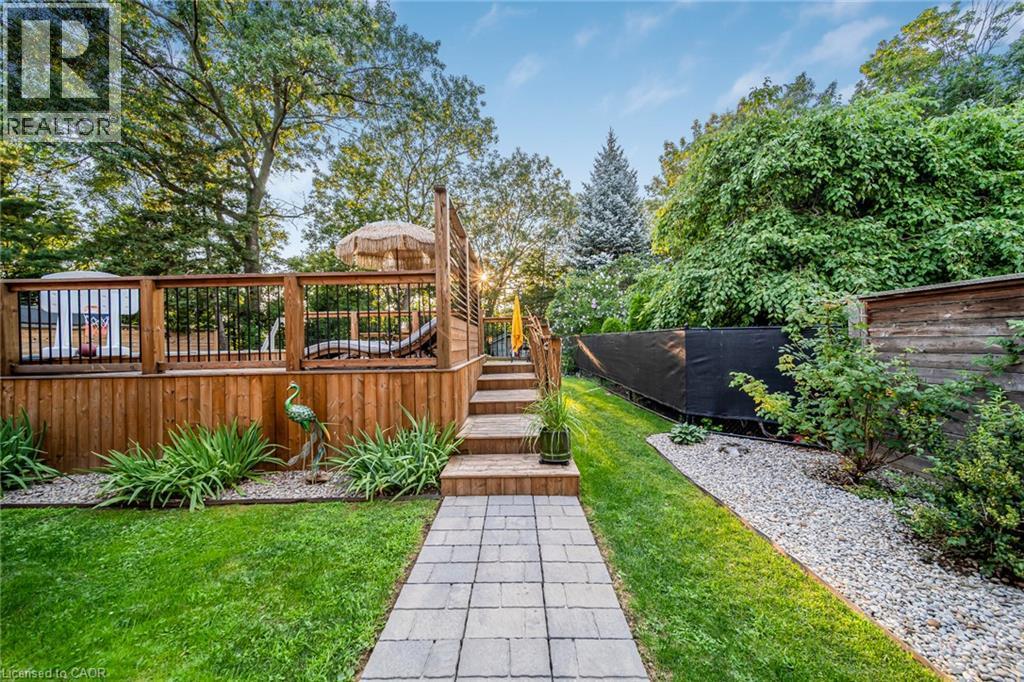 Multi-level wood deck with black metal balusters and built-in privacy screen - 24 Garvey Crescent, Hamilton, ON - Outdoor With Deck Patio Veranda