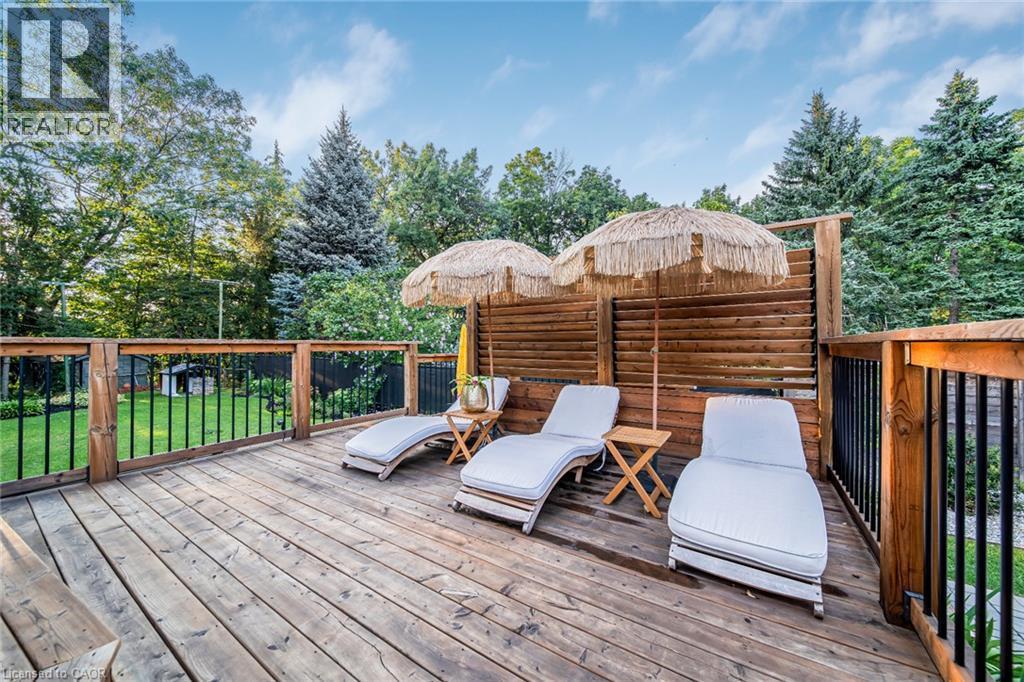 Expansive wood deck with a privacy fence, wood railings, and black metal balusters - 24 Garvey Crescent, Hamilton, ON - Outdoor With Deck Patio Veranda With Exterior