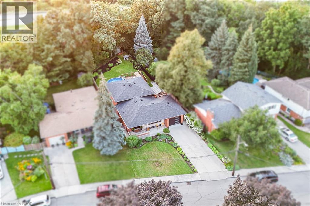 Two-story residence with a dark shingle roof, attached garage, and a concrete driveway - 24 Garvey Crescent, Hamilton, ON - Outdoor With View