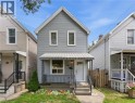 Two-story exterior with horizontal siding, a covered front porch with metal railings, and a white entry door - 56 Harmony Avenue, Hamilton, ON  - Outdoor With Deck Patio Veranda 