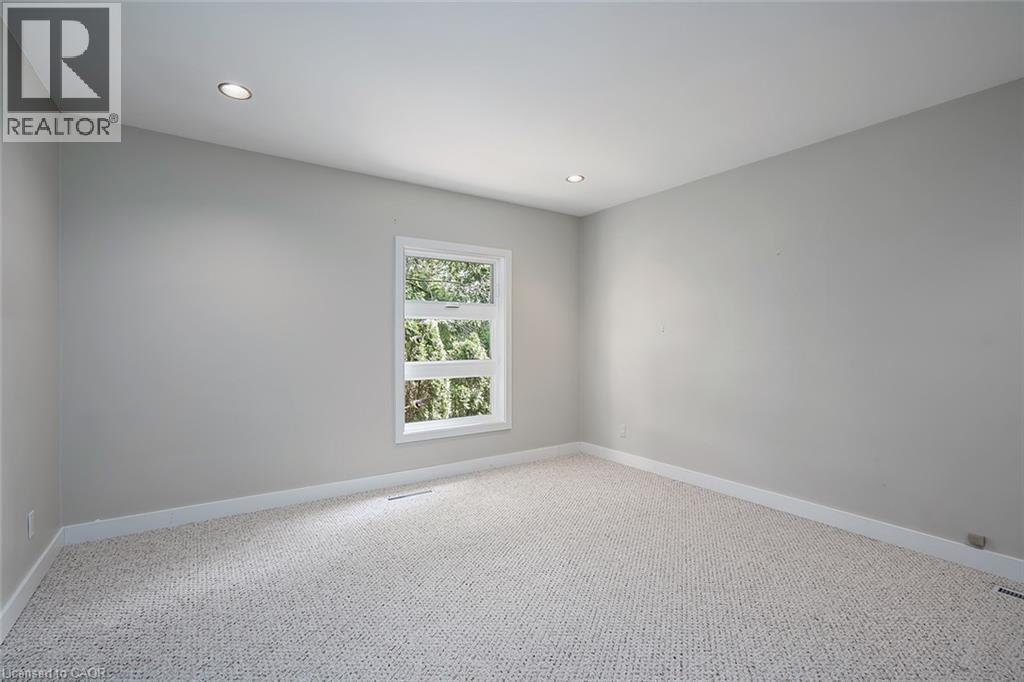 Bright, light-filled bedroom showcasing neutral wall finishes, recessed ceiling lighting, and plush carpeting throughout - 4189 Inglewood Drive, Burlington, ON - Indoor Photo Showing Other Room