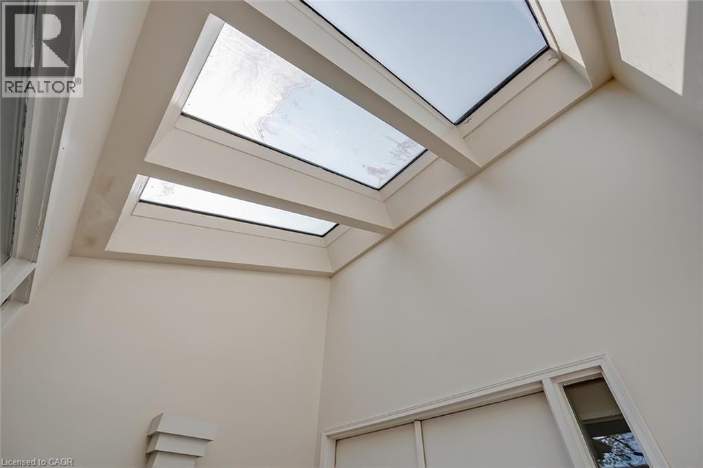 Multiple skylights set into a sloped ceiling - 4189 Inglewood Drive, Burlington, ON - Indoor Photo Showing Other Room
