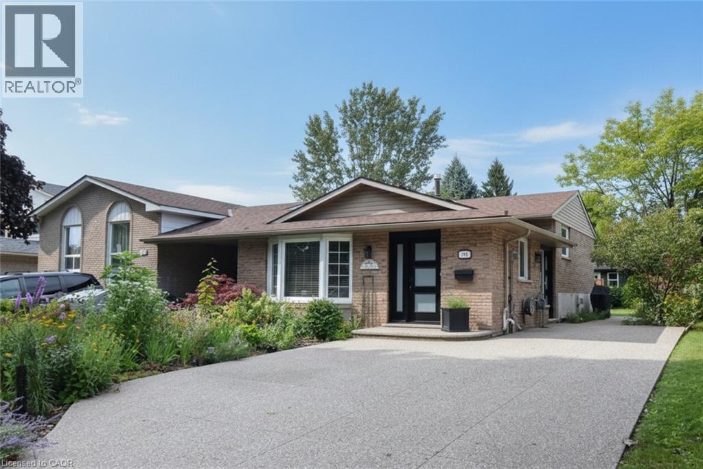 Brick exterior with a peaked roofline, bay window, and a modern front entry door - 374 Brigadoon Drive, Hamilton, ON - Outdoor With Facade