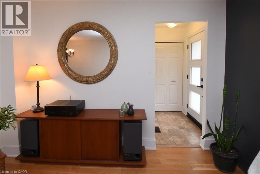 Entryway featuring a white paneled door with frosted glass inserts, tile flooring, and bi-fold closet doors - 374 Brigadoon Drive, Hamilton, ON - Indoor