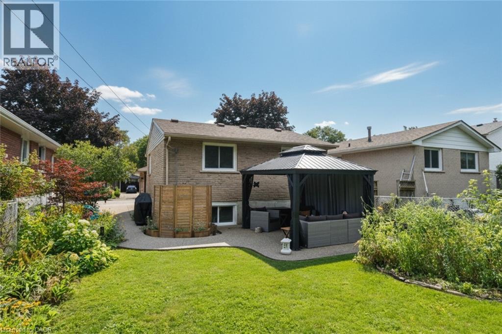 Expansive lawn with a stone patio area, featuring a covered gazebo with privacy screens - 374 Brigadoon Drive, Hamilton, ON - Outdoor