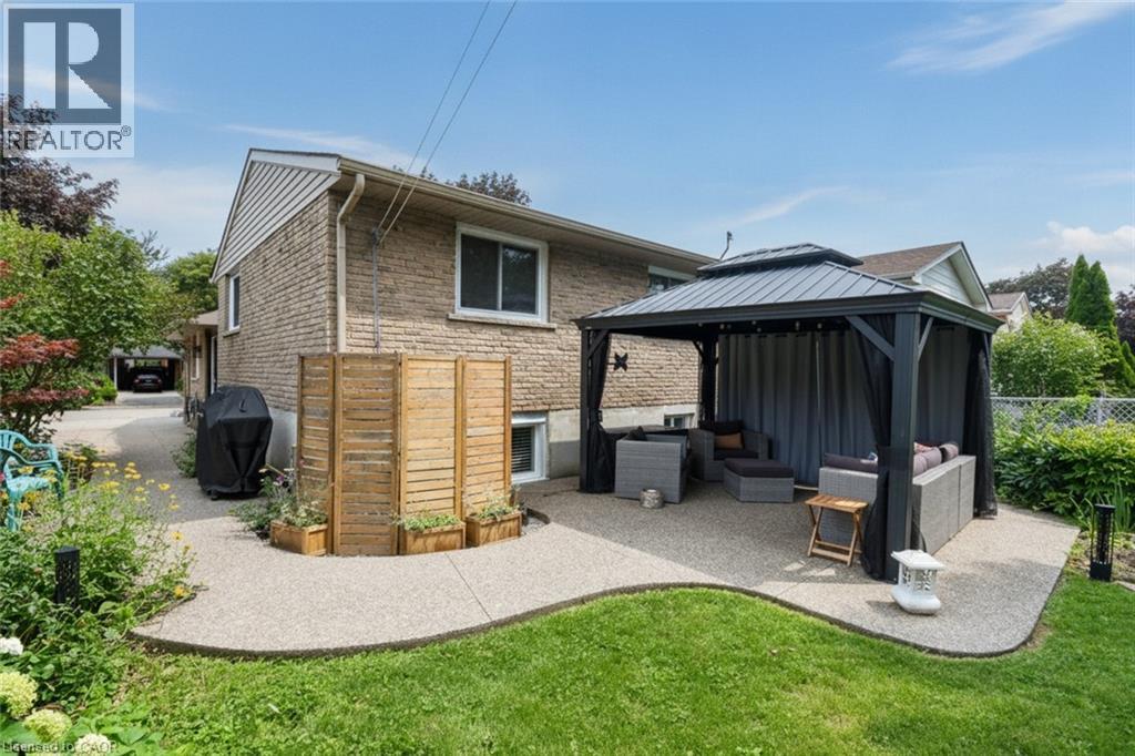 Expansive exterior patio with a freestanding gazebo, featuring a gravel-finish surface and surrounding green space - 374 Brigadoon Drive, Hamilton, ON - Outdoor