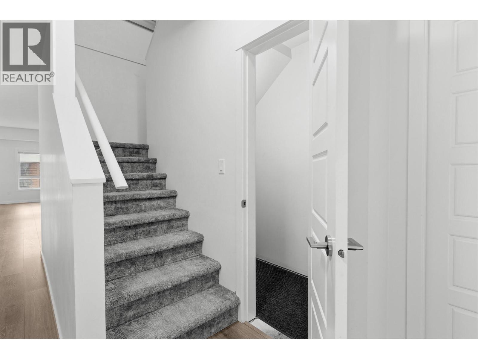 Front entrance foyer with spacious storage closet and staircase to 2nd floor - 680 Old Meadows Road Unit# 74, Kelowna, BC - Indoor Photo Showing Other Room