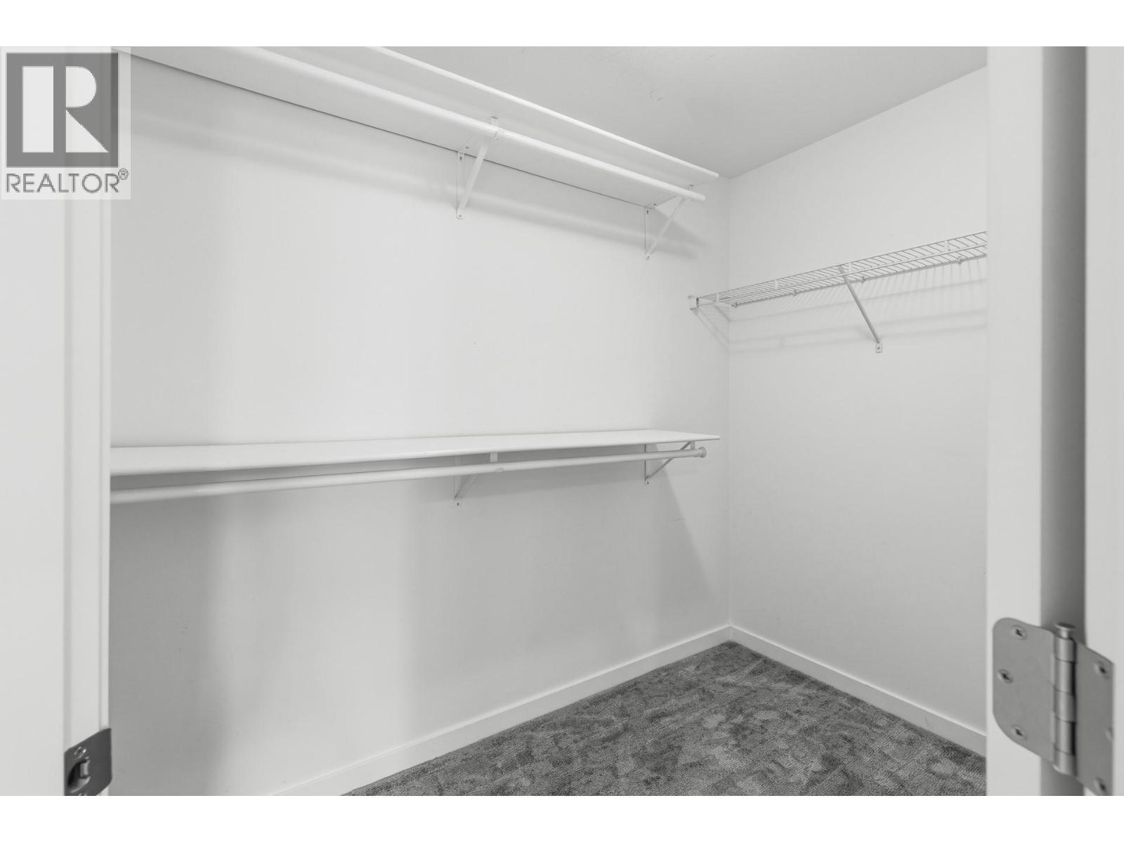 Primary bedroom walk-in closet - 680 Old Meadows Road Unit# 74, Kelowna, BC - Indoor With Storage