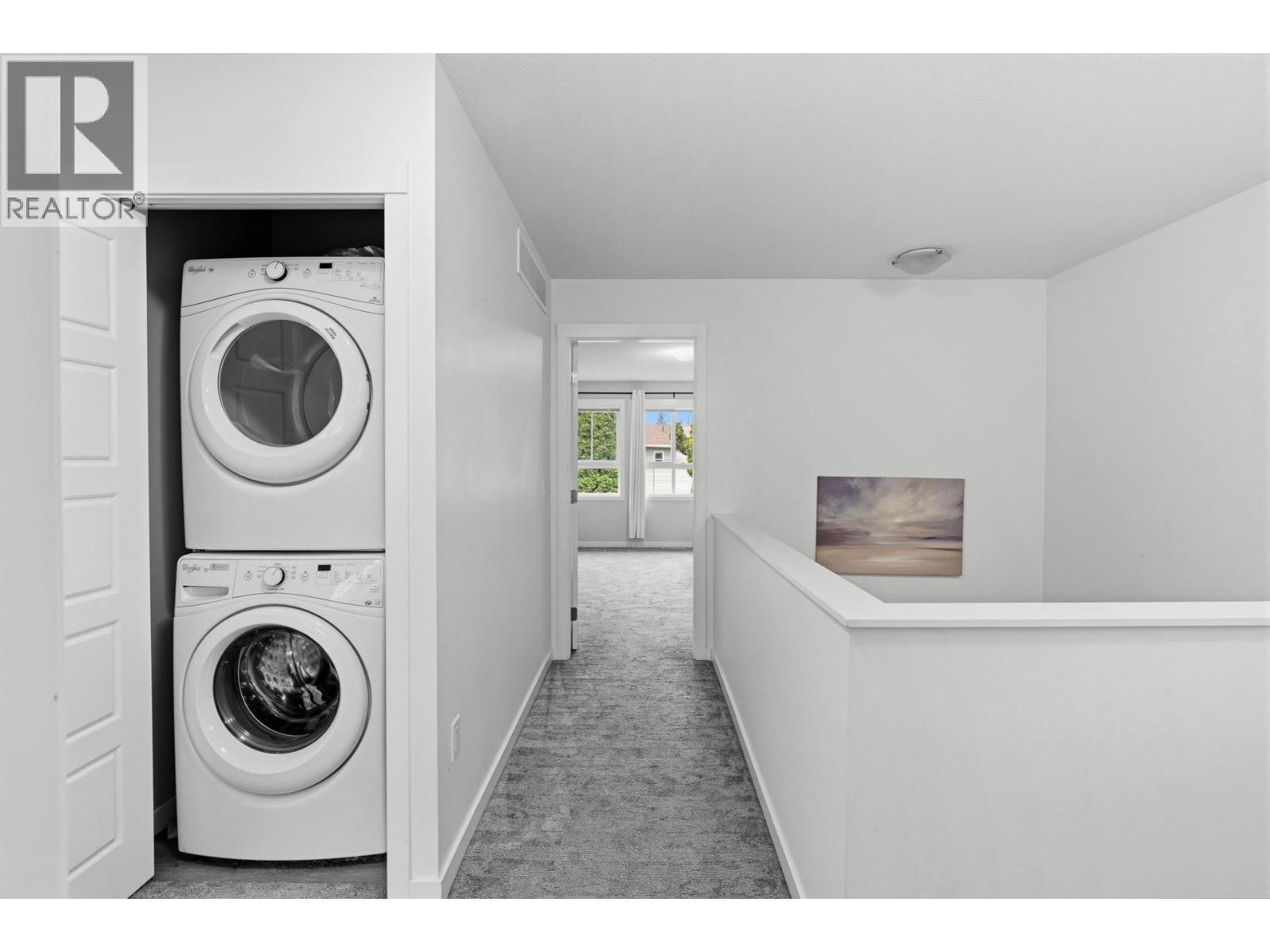 2nd floor landing with laundry closet - 680 Old Meadows Road Unit# 74, Kelowna, BC - Indoor Photo Showing Laundry Room