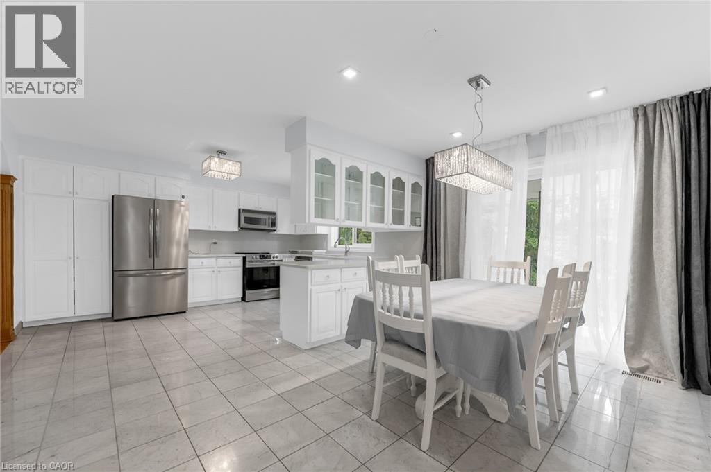 Spacious kitchen featuring white cabinetry, stainless steel appliances, recessed lighting, and tile flooring - 35 Glen Park Court, Hamilton, ON - Indoor