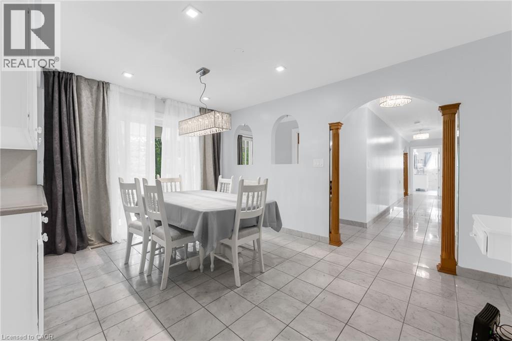 Recessed lighting, tile flooring, archway with wood columns, built-in wall niche, and chandelier lighting fixture - 35 Glen Park Court, Hamilton, ON - Indoor Photo Showing Dining Room