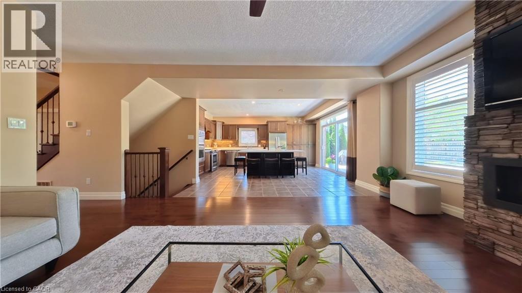 Hardwood-finish flooring throughout the living area - 913 Valebrook Court, Kitchener, ON - Indoor Photo Showing Living Room With Fireplace