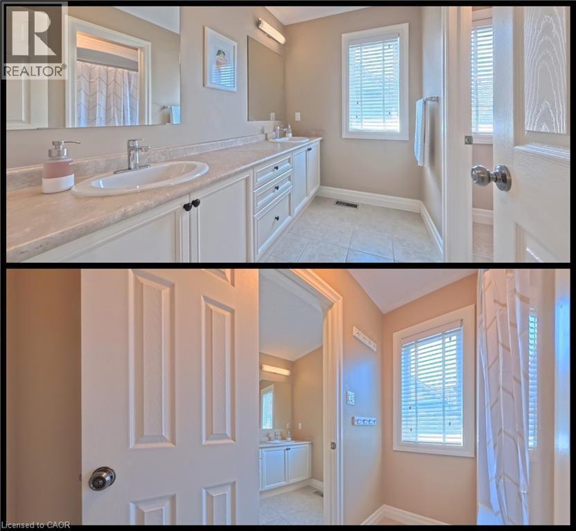 Property Image. Displaying a bathroom area with vanity, mirror, window, and shower curtain - 913 Valebrook Court, Kitchener, ON - Indoor Photo Showing Bathroom