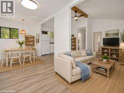 Wood-finish flooring throughout, with a recessed ceiling light in the dining area - 