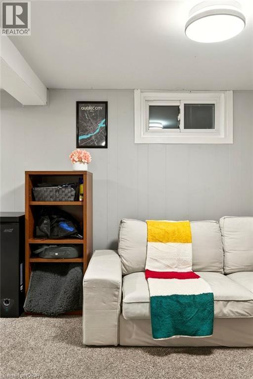 Recessed lighting, wood-finish shelving unit, sliding window, overhead flush-mount light fixture, and carpeted flooring - 23 Kipling Road, Hamilton, ON - Indoor