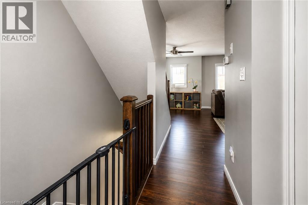 Hallway with wood-finish flooring, light gray walls, and white trim - 750 Lawrence Street Unit# 86, Cambridge, ON - Indoor Photo Showing Other Room