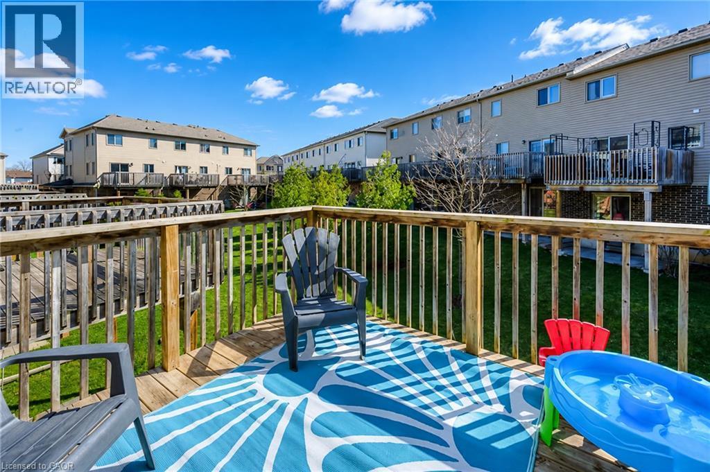 Expansive wood deck with a full wood railing, providing an elevated outdoor living area - 750 Lawrence Street Unit# 86, Cambridge, ON - Outdoor With Deck Patio Veranda With Exterior