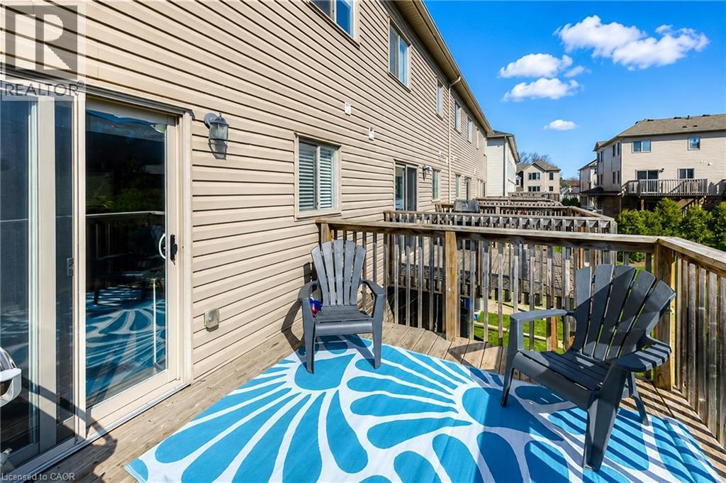 Exterior wood deck with a sliding glass door and tan horizontal siding - 750 Lawrence Street Unit# 86, Cambridge, ON - Outdoor With Deck Patio Veranda With Exterior