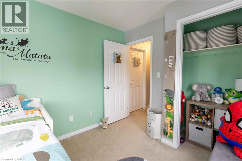 Carpeted flooring, painted walls, white trim, and a built-in closet with shelving - 750 Lawrence Street Unit# 86, Cambridge, ON - Indoor Photo Showing Bedroom