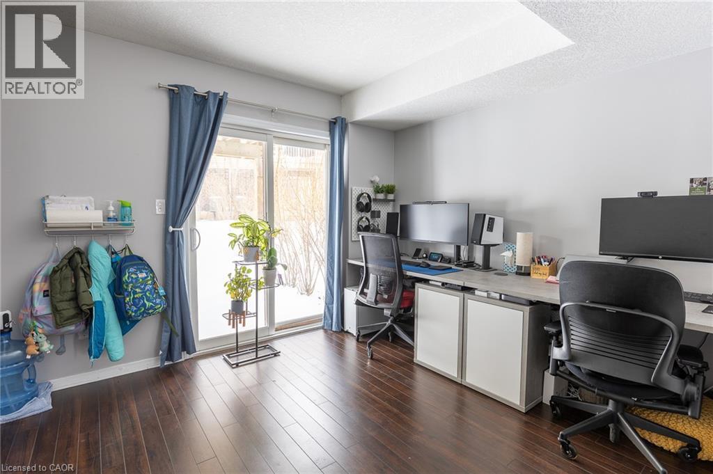 Wood-finish flooring, light gray wall paint, and a sliding glass door - 750 Lawrence Street Unit# 86, Cambridge, ON - Indoor Photo Showing Office