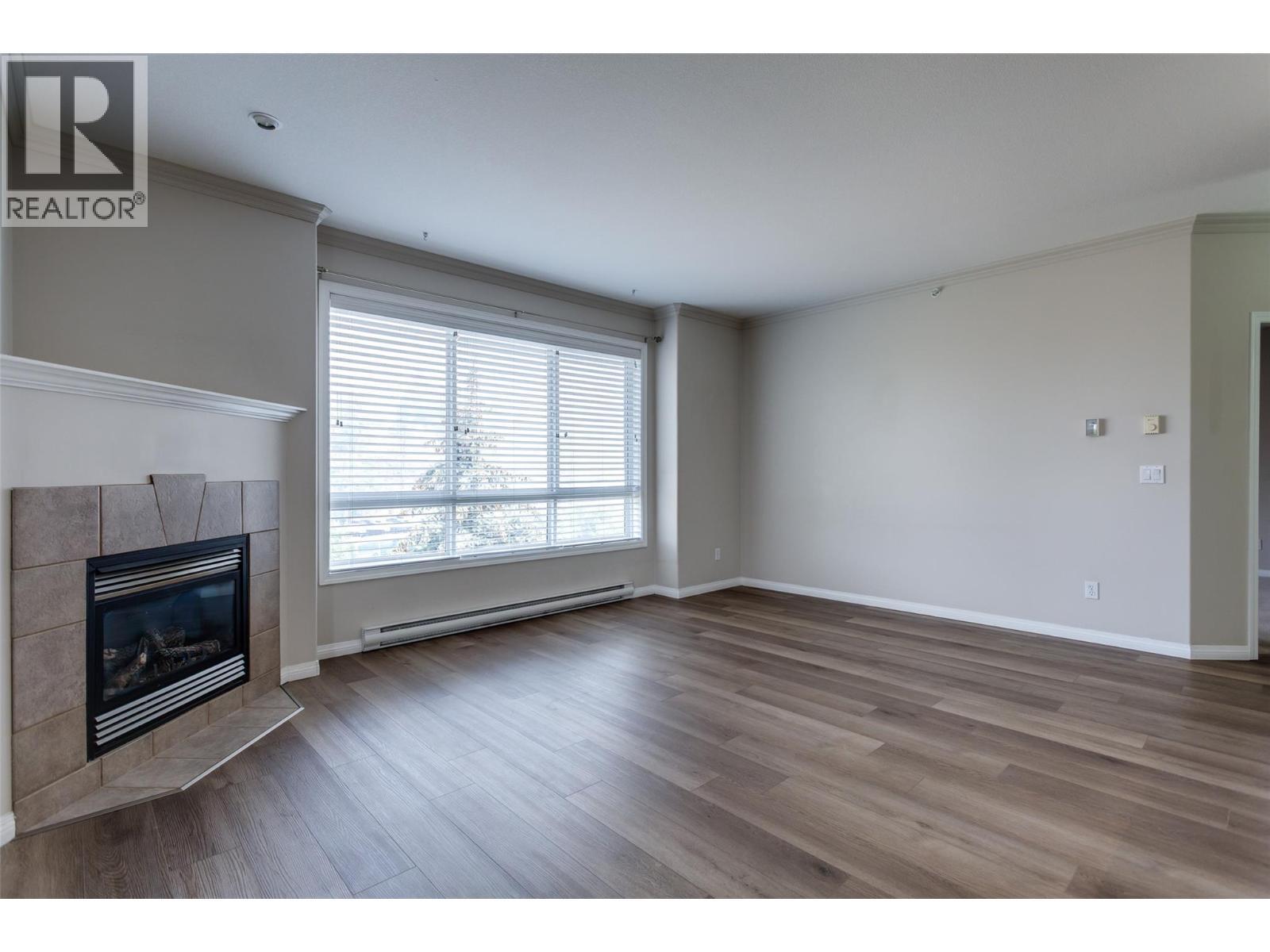 1962 Enterprise Way Unit# 401, Kelowna, BC - Indoor Photo Showing Other Room With Fireplace