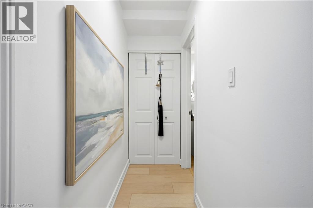 Light wood-finish flooring with white baseboards - 8 Woodman Drive S Unit# 708, Hamilton, ON - Indoor Photo Showing Other Room