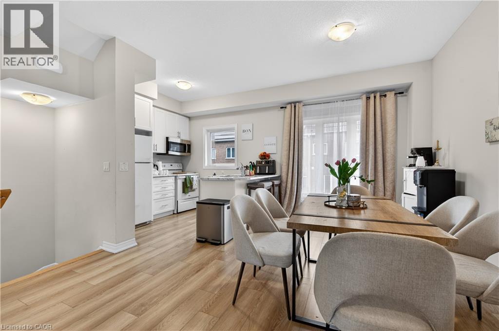 Kitchen with white cabinetry, stainless steel appliances, and a window with a white frame - 19 Picardy Drive Unit# 13, Hamilton, ON - Indoor Photo Showing Dining Room