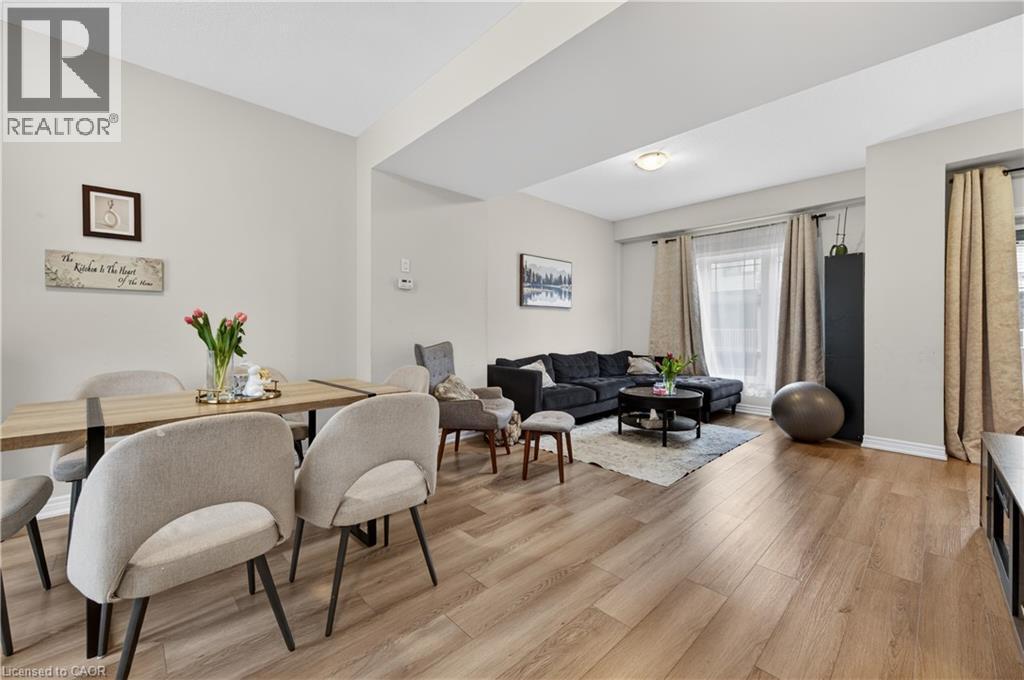 Open-concept living space featuring wood-finish flooring, recessed lighting, and ample natural light - 19 Picardy Drive Unit# 13, Hamilton, ON - Indoor
