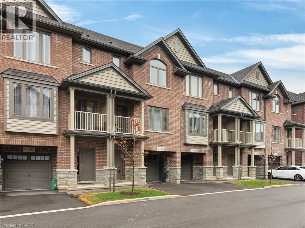 Red brick exterior with stone accents, bay windows, covered entrance, and an attached garage - 19 Picardy Drive Unit# 13, Hamilton, ON - Outdoor With Facade